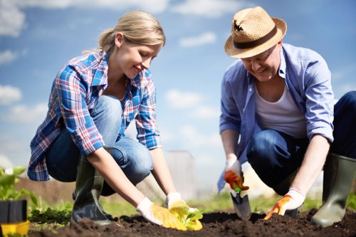 Front view of a gardener at work in a residential garden